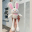 A white plush rabbit with ears and legs that can be pulled to make them longer or shorter