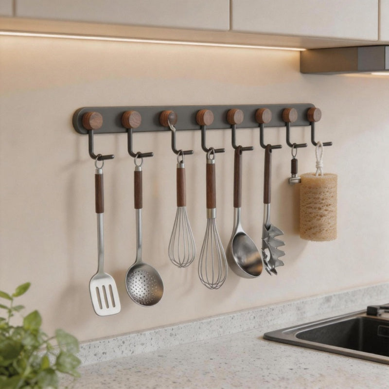 Natural loofah sponge hanging on a kitchen wall hook alongside cooking utensils.
