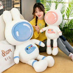 Girl holding pink and blue space bunny plush toys, size comparison of large and small astronaut rabbit stuffed animals, lifestyle product display for kids gift