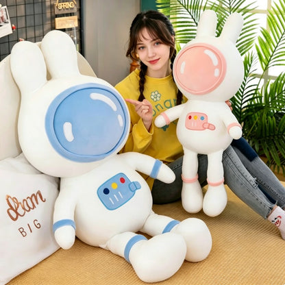 Girl holding pink and blue space bunny plush toys, size comparison of large and small astronaut rabbit stuffed animals, lifestyle product display for kids gift
