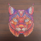 Colorful lynx head wooden puzzle with intricate patterns displayed on a dark wood background.