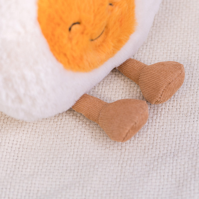 Close up detail of corduroy textured legs on boiled egg plush toy, premium fabric workmanship display for soft food stuffed doll product