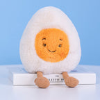 Adorable soft boiled egg plush toy with happy squinting smile face, fluffy white egg body and corduroy legs, cute food shaped stuffed doll for kids gift home decor