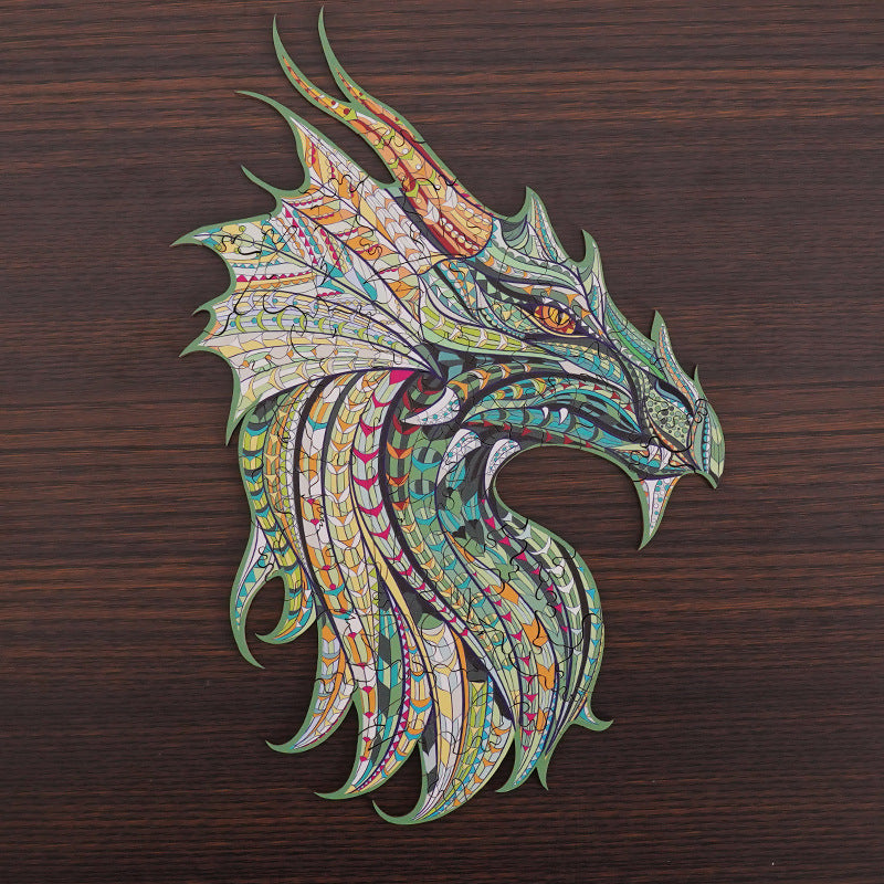 Intricate dragon head wooden puzzle with colorful scale patterns displayed on a dark wood background.