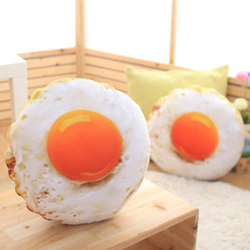 Two realistic fried egg pillow plush toys displayed in cozy home scene, soft funny food shaped stuffed throw cushion for living room decor Main image
