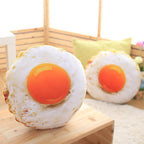 Two realistic fried egg pillow plush toys displayed in cozy home scene, soft funny food shaped stuffed throw cushion for living room decor