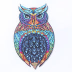 Colorful owl-shaped wooden puzzle with blue and purple mandala patterns on white background.