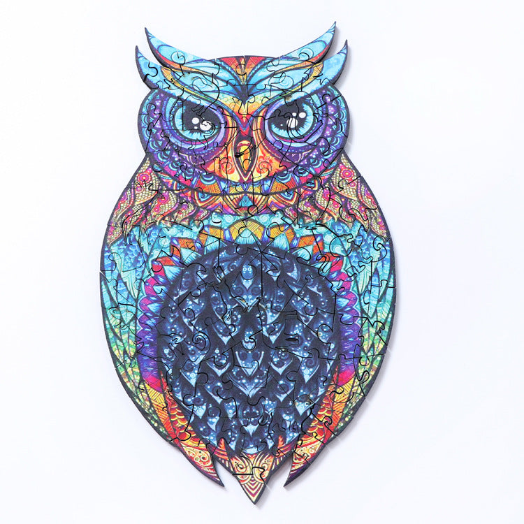 Colorful owl-shaped wooden puzzle with blue and purple mandala patterns on white background.