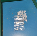 Small plastic bag containing spare wooden puzzle pieces.